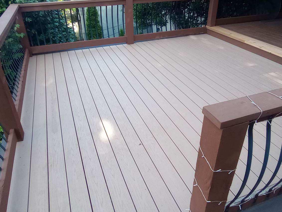 Close-up of a TimberTech composite deck floor with decorative wrought-iron railing